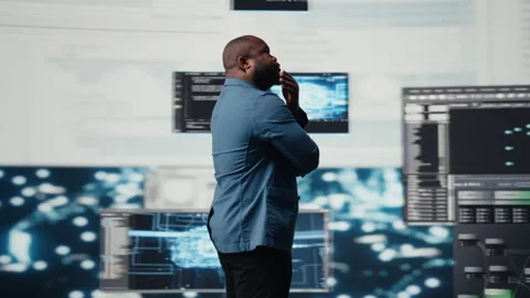 Black programmer expert engaging in software development at high tech workspace Stock Footage 312360222