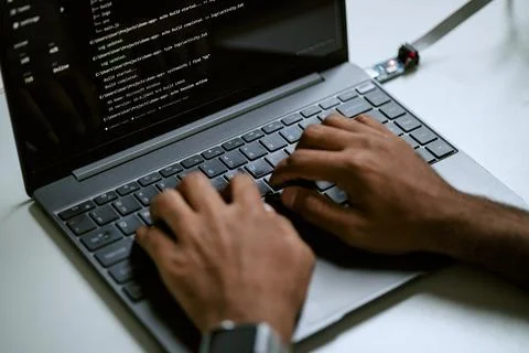 Black Programmer Typing Code on Laptop Keyboard for Software Development Stock Photos
