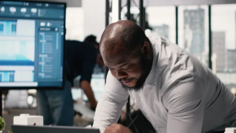 Black property engineer collecting construction details on blueprints sketch Stock Footage 316795276