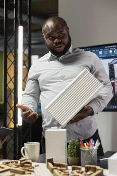 Black property engineer presenting construction details on 3D models Foto stock