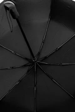 Black protective umbrella against rain and sun Stock Photos