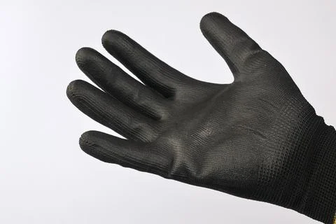 Black protective work glove isolated on white background. Photos
