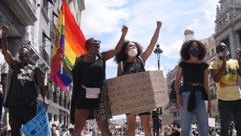 Black protesters screaming and waving flag during BLM demonstration, Madrid Stock Footage 234290895