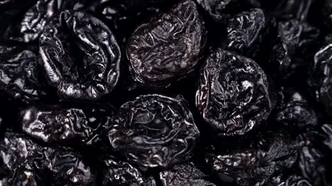 Black prunes or dried plums circle rotation close up top view Stock Footage 273721045