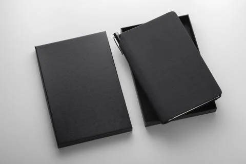 Black pu leather notebook in box with pen holder, mockup on grey background,  Фото
