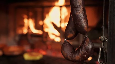Black pudding slowly grilling in fireplace Video stock 297801241