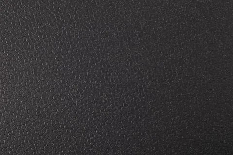 Black PVC plastic texture. Dark, rough material. Abstract background. Stock Photos