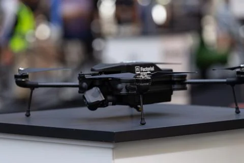 Black quadcopter drone on display at an event Stock Photos