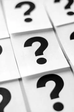 Black question marks on white sheets 스톡 사진