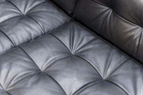 Black Quilted Leather Sofa Corner Close Up with Soft Cushioned Texture Details Stock Photos