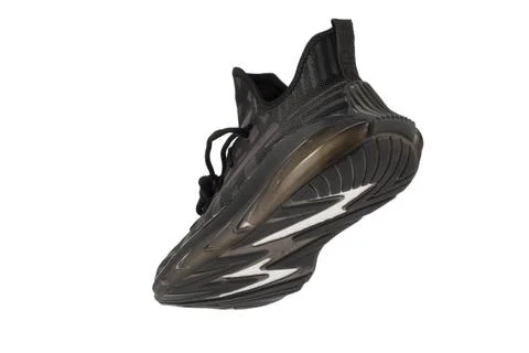 Black rag sneaker on a white background. Stock Photos