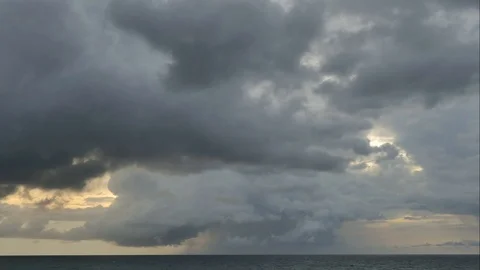The black rain clouds were moving slowly at sunset time. 库存影片 118592744