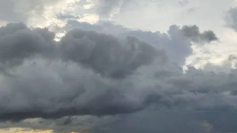The black rain clouds were moving slowly at sunset time. Stock-Footage 118592751