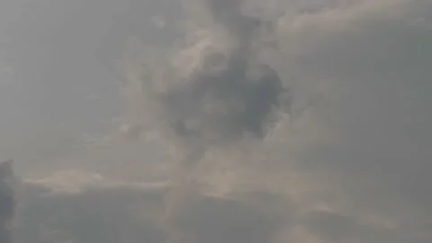 Black raincloud forming bigger in cloudy sky and fading in the last Stock Footage 239528552