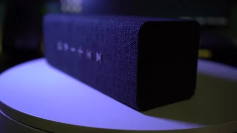 A black rectangular bluetooth speaker on a turntable Stock Footage
