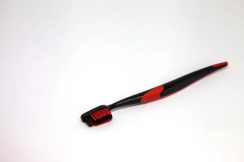 Black red toothbrush on the table Stock Photos
