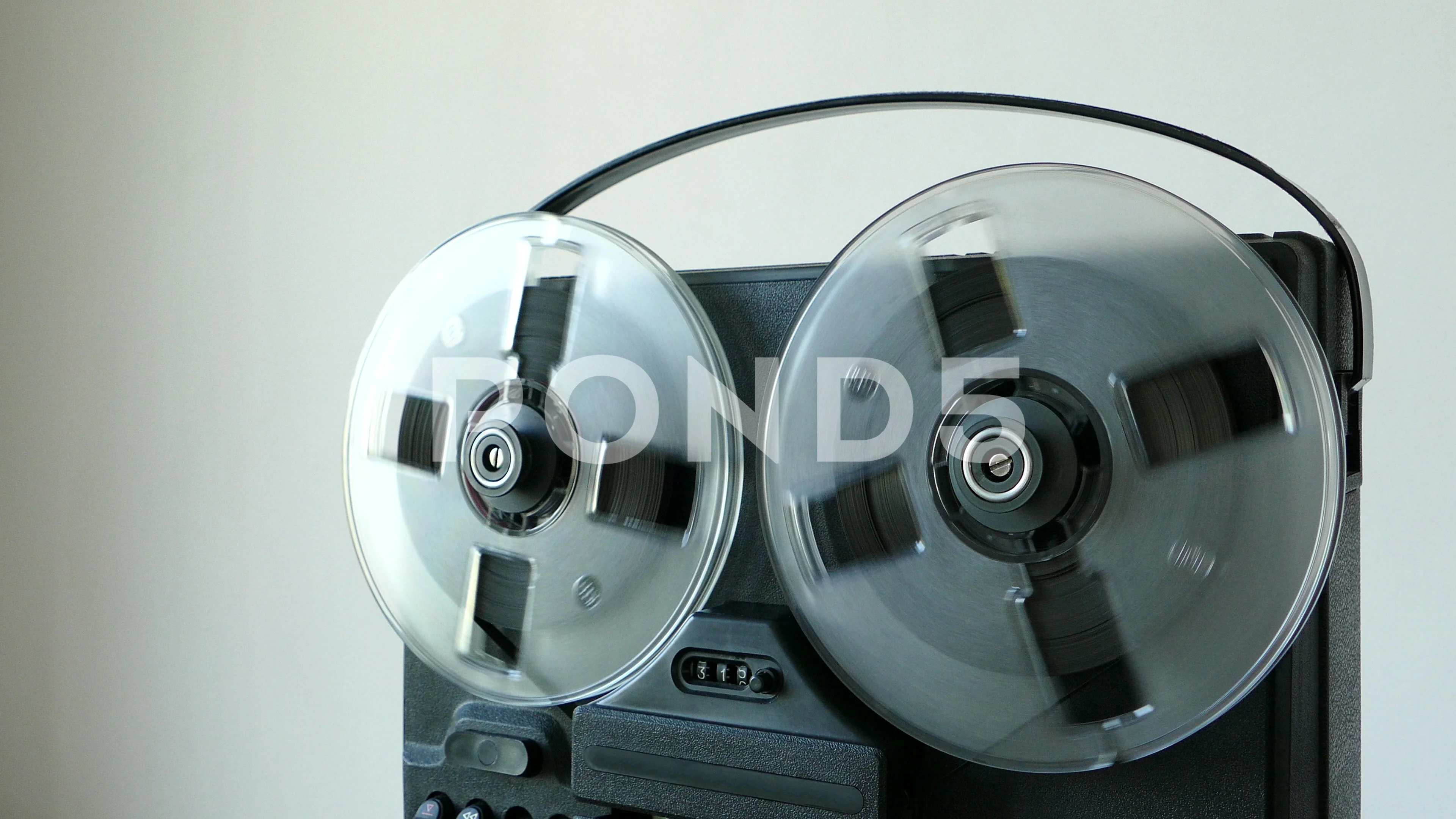 Vintage reel-to-reel tape recorder with spinning reels was made in