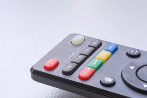 Black remote control on white background closeup with copyspace. 스톡 사진