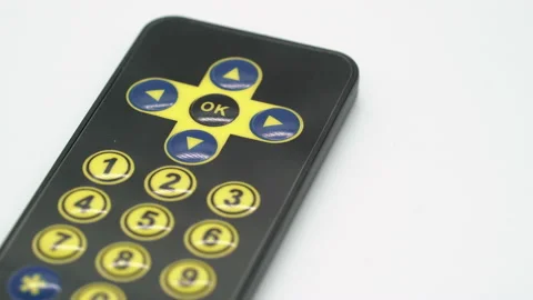 Black remote controller for electronic device or TV. Yellow sensor buttons. Vídeo Stock 169318083