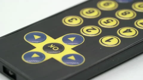 Black remote controller for electronic device or TV. Yellow sensor buttons. Vidéo 169665389
