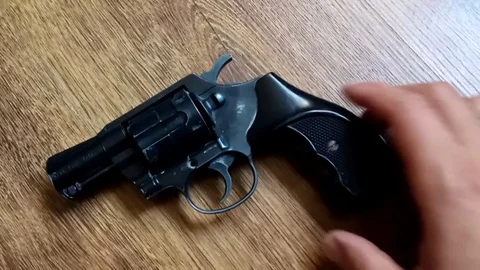 Black revolver on an unusual background Stock Footage 110803828