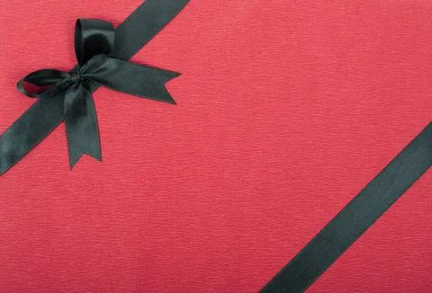 Black ribbon on red background Stock Photos