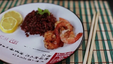 Black rice, fried shrimp on plate Stock Footage 82644048