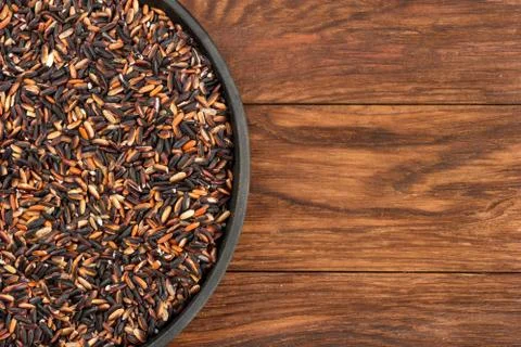 Black rice in pan Stock Photos