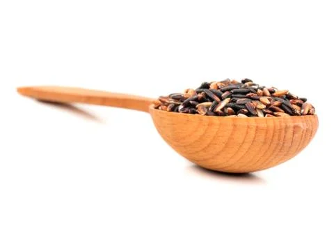 Black rice in a spoon Stock Photos
