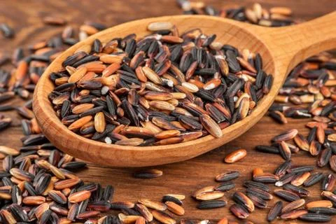 Black rice in spoon Stock Photos