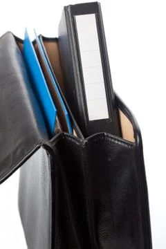 Black ring binder in an open briefcase Stock Photos