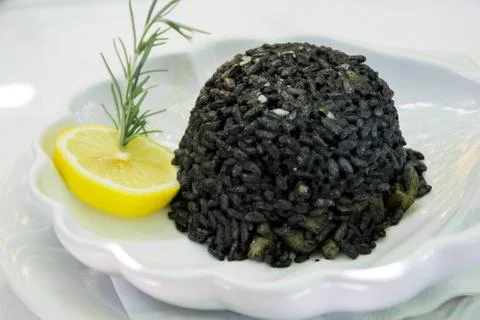 Black risotto and squid Stock Photos