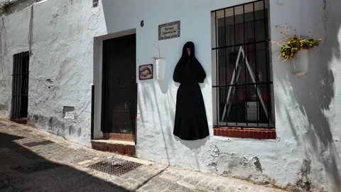 Black robe decoration on white wall, Vejer de la Frontera, Andalusia, Spain Stock Footage 346282931