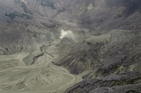 Black rock formations inside a volcano caldera Stock Photos