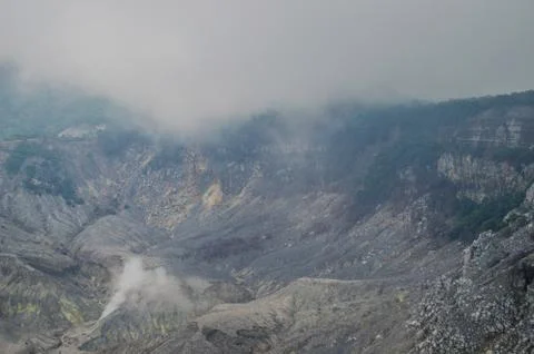 Black rock formations inside a volcano caldera Stock Photos