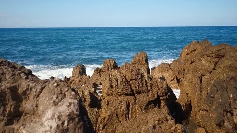 Black rocks and waves Stock Footage 97845504