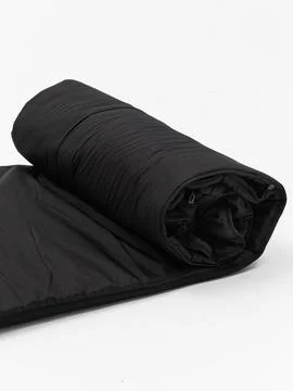 Black rolled sleeping bag variant three Stock Photos