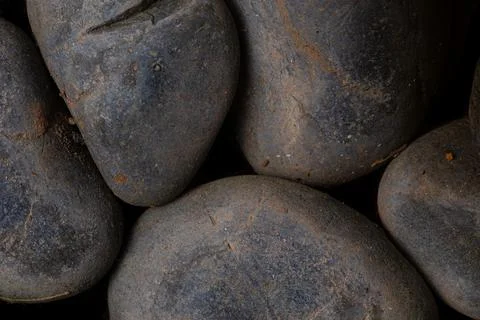 Black round cobble stone texture for wallpaper and background. Stock Photos