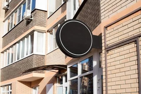 Black round logo on brick wall building exterior for mockup design Fotos de archivo