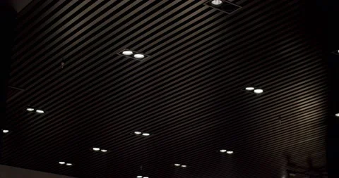 Black round modern ceiling lamp in modern interior with black wooden lines Stock Footage 197780861