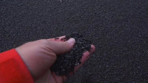 Black Sand Beach Close Up POV Hand Picks Up Pebble Sand Reynisfjara Iceland Stock Footage 258491594