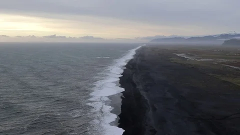 Black sand beach ,Rocks and cliffs at ocean beach. Snowy beach of Iceland. Stock Footage 118246704