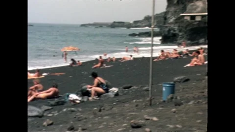 Black Sand Beach with Sunbathers Stock Footage 278240561