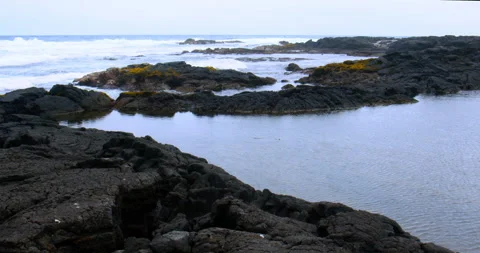 Black Sand Beach tide pool with waves on volcanic shore in Hawaii Stock Footage 330548933