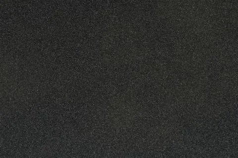 Black sandpaper texture with rough surface showing fine grain details clearly Stock Photos