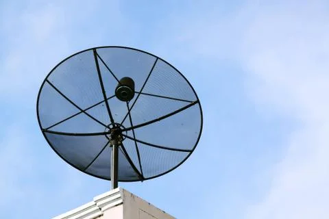 Black satellite dish, blue sky Stock Photos