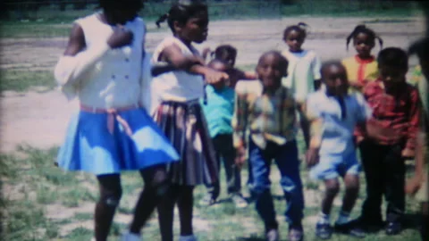 Black school children exercise on the play ground 1950s family home movie 7060 Stock Footage 201154106