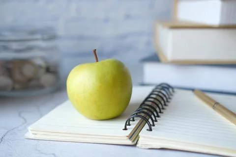 Black to school concept with apple on notepad on table. 写真素材