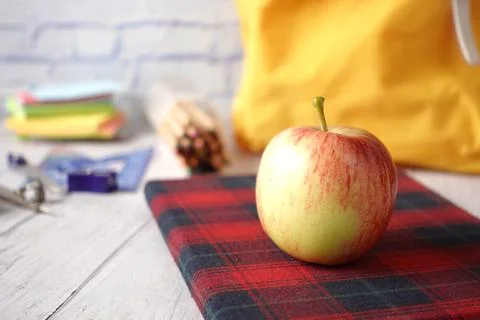 Black to school concept with apple on notepad on table. 写真素材