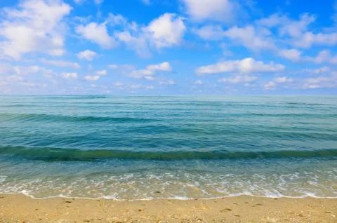 Black sea beach blue sky sand sun daylight Stock Photos